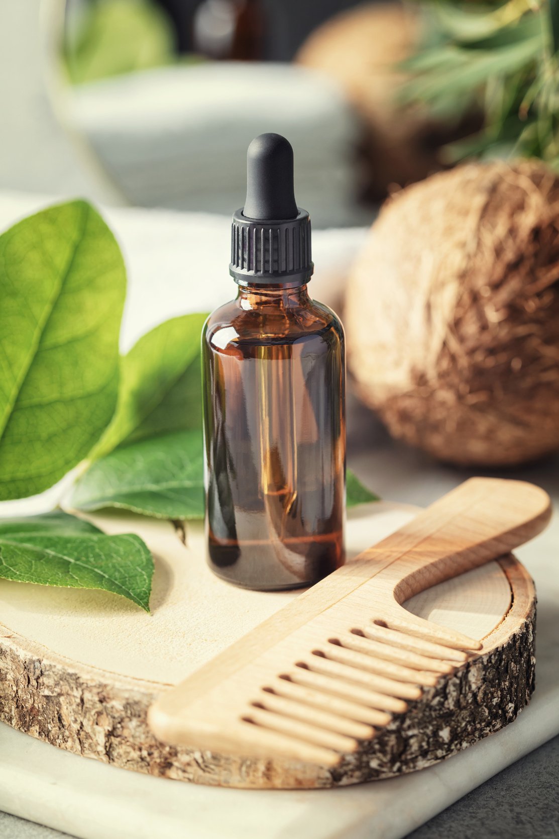 Natural Organic Coconut Oil in Amber Glass Bottle and Wooden Hair Brush, Natural Cosmetics, Coconut Oil Hair Treatment Concept